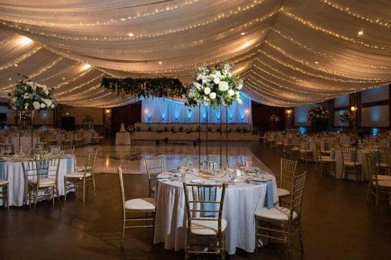 Full ceiling linear fabric draping installation by ILLUME for a luxury wedding reception at Seven Springs Mountain Resort in the Laurel Highlands.