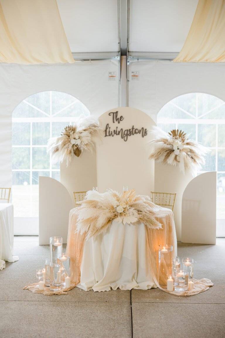 Bohemian-style sweetheart table with custom draping, pampas grass, and romantic lighting at Linden Hall in Dawson, PA.