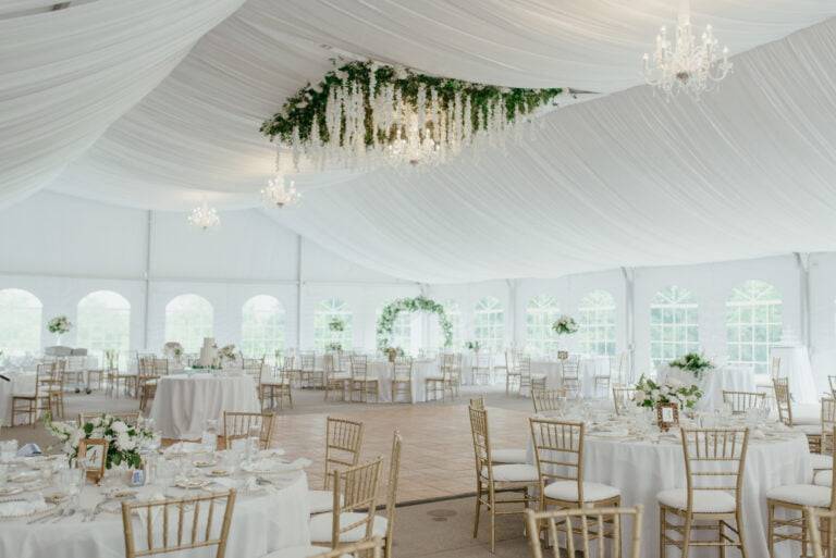 Luxury full satin tent ceiling liner with a custom square floral chandelier by ILLUME for a wedding at Linden Hall in Dawson, PA.