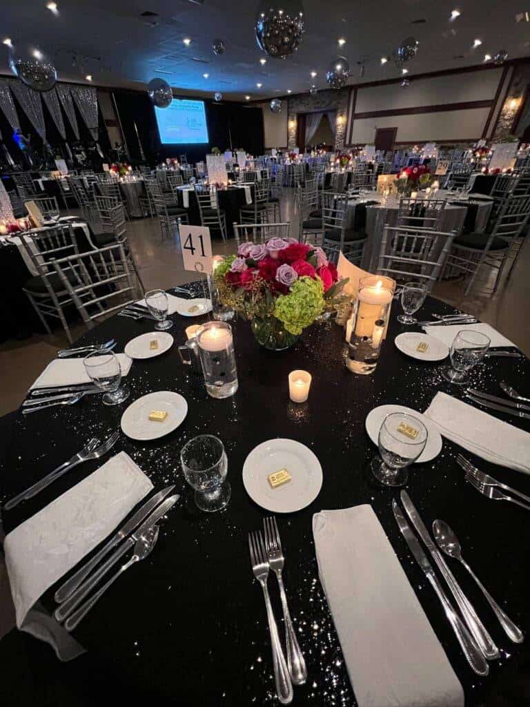 Luxury gala tablescape design by ILLUME for the Community Foundation of Fayette County Gala of Giving 2024 at Seven Springs Mountain Resort, featuring custom linens and floral accents.