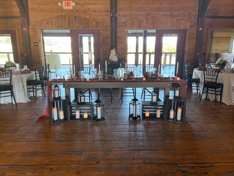 Luxury farm table reception design by ILLUME at Lingrow Farm in Leechburg, PA, featuring elegant tabletop decor and atmospheric lighting.