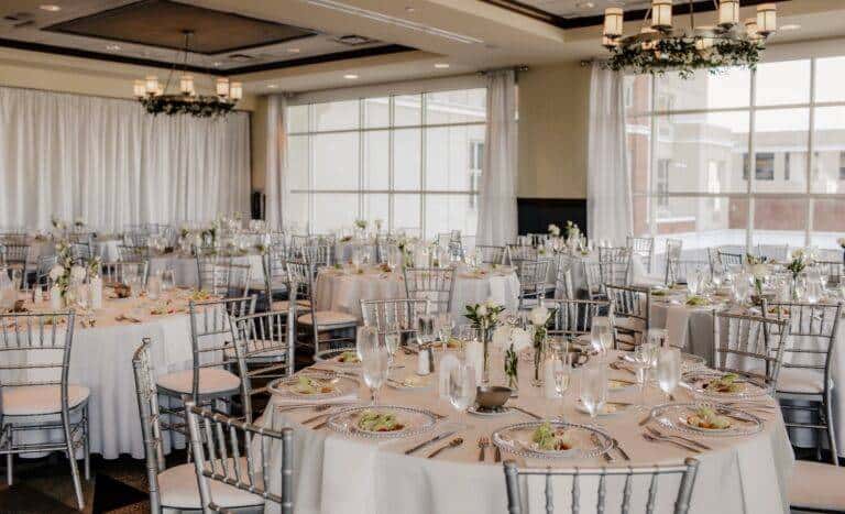Custom floor-to-ceiling satin window treatments and event draping by ILLUME at the Sheraton Erie Bayfront Hotel, overlooking Lake Erie.