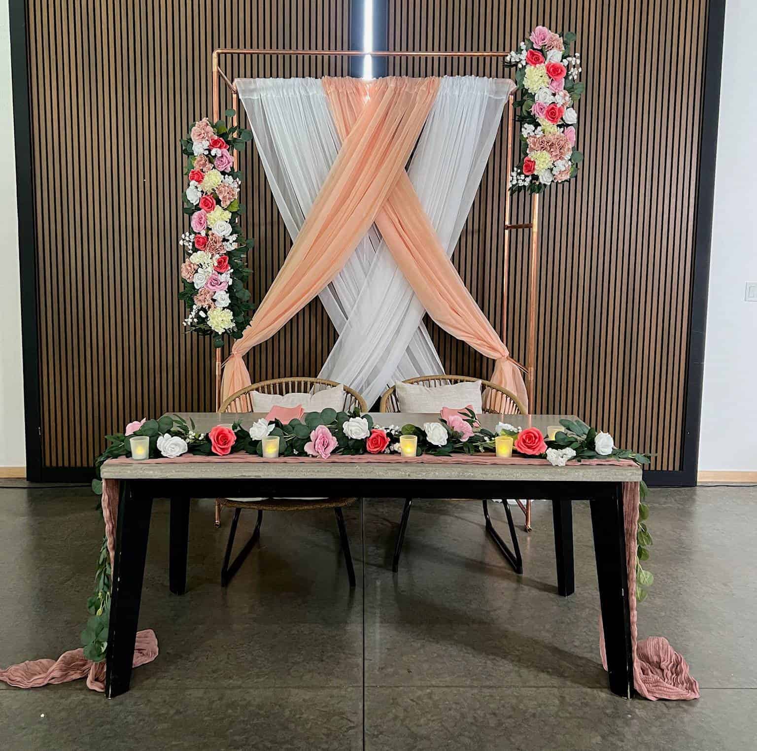 Modern copper ceremony arch with romantic white draping by ILLUME at The Harper Event Venue in Meadville, PA.