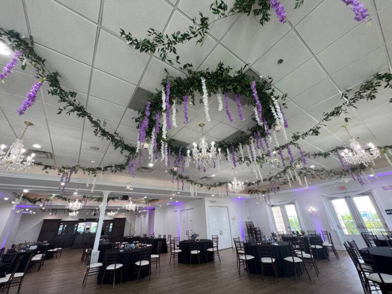 Luxury full-room wedding transformation at Twelve Oaks Mansion in Mars, PA, featuring lush greenery, white florals, and custom event lighting by ILLUME.
