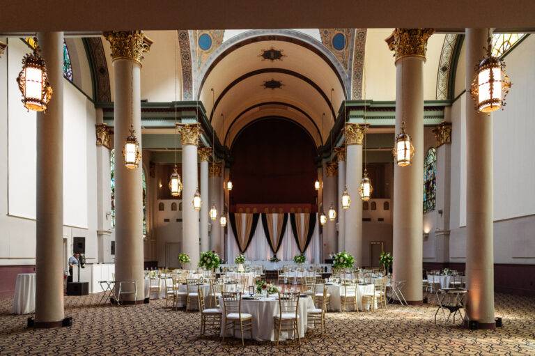 Luxury white, black, and gold satin wedding backdrop designed by ILLUME at The Priory Grand Hall in Pittsburgh’s North Shore neighborhood.
